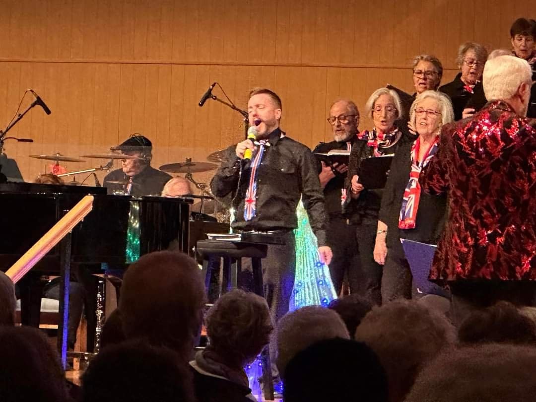 Travis singing a solo with CAMP Rehoboth Chorus on stage